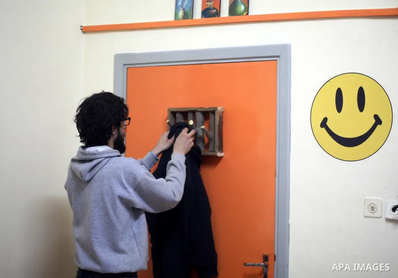 Azad Shams, a 25-year-old Palestinian artist, hangs his jacket on a handmade wood hanger at his workshop, in the West Bank city of Ramallah, February 25, 2015. Shams works with used wood boards and pieces to make artisti...