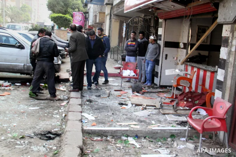 Egyptians gather at one of the blast sites after the explosion in the Imbaba area in Giza, outskirt of Cairo, Egypt, on Feb. 26, 2015. Six bombs detonated in the greater Cairo area in Egypt early on Thursday morning, kil...
