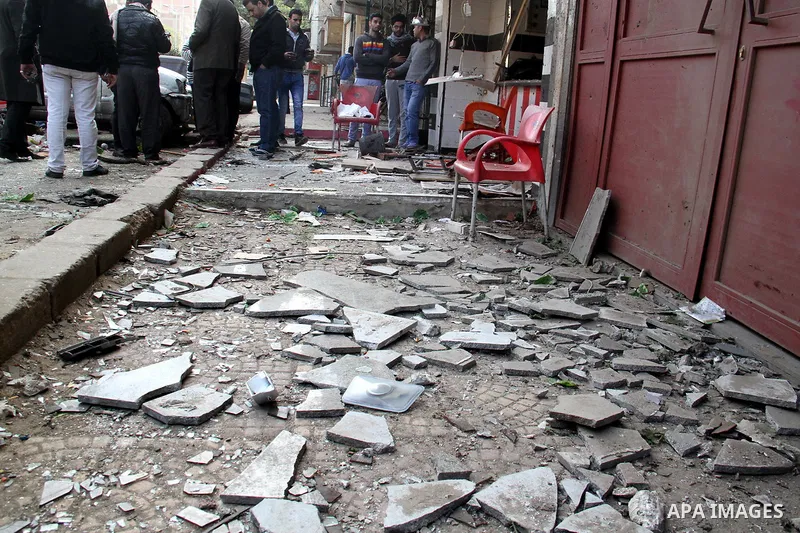 Egyptians gather at one of the blast sites after the explosion in the Imbaba area in Giza, outskirt of Cairo, Egypt, on Feb. 26, 2015. Six bombs detonated in the greater Cairo area in Egypt early on Thursday morning, kil...