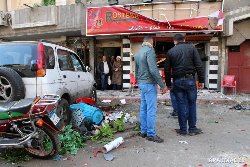 Egyptians gather at one of the blast sites after the explosion in the Imbaba area in Giza, outskirt of Cairo, Egypt, on Feb. 26, 2015. Six bombs detonated in the greater Cairo area in Egypt early on Thursday morning, kil...