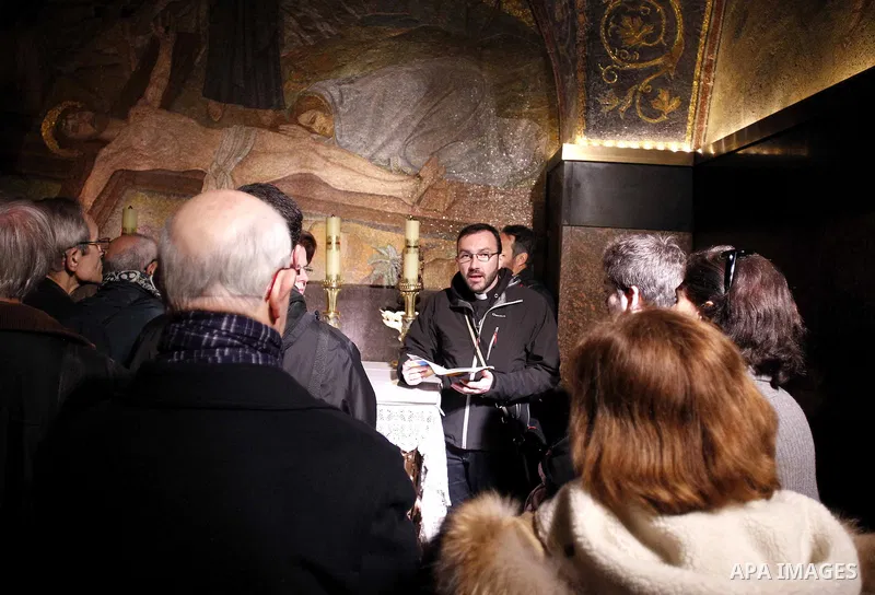 Christian pilgrims pray at the Church of the Holy Sepulchre in Jerusalem's Old city February 26, 2015. A fire damaged a Greek Orthodox seminary in Jerusalem on Thursday and "anti-Christian" graffiti was found at the scen...