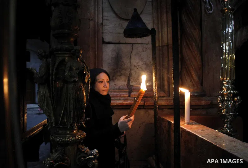 A christian pilgrim prays at the Church of the Holy Sepulchre in Jerusalem's Old city February 26, 2015. A fire damaged a Greek Orthodox seminary in Jerusalem on Thursday and "anti-Christian" graffiti was found at the sc...