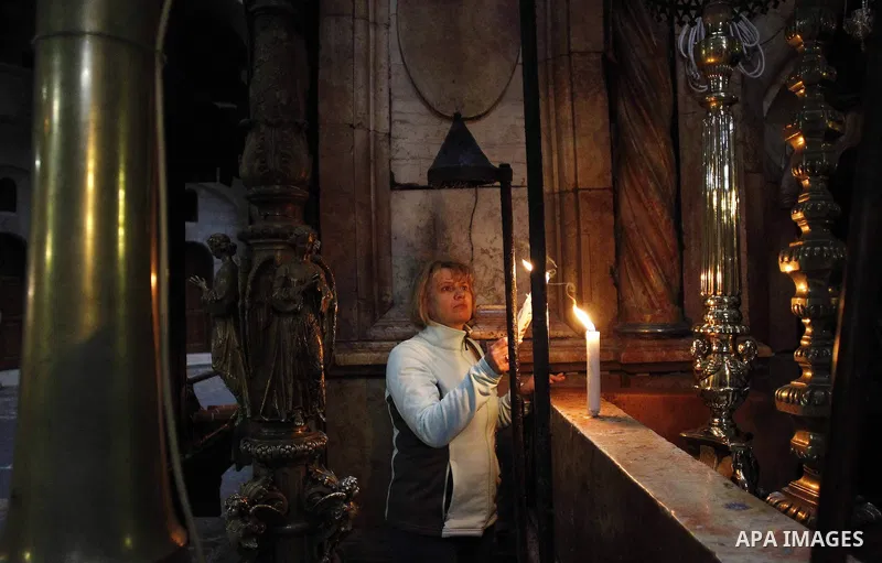 A christian pilgrim prays at the Church of the Holy Sepulchre in Jerusalem's Old city February 26, 2015. A fire damaged a Greek Orthodox seminary in Jerusalem on Thursday and "anti-Christian" graffiti was found at the sc...