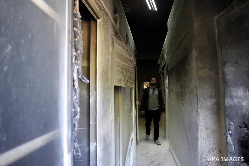A man looks at damage at a Greek Orthodox seminary in Jerusalem February 26, 2015. A fire damaged a Greek Orthodox seminary in Jerusalem on Thursday and "anti-Christian" graffiti was found at the scene in what Israeli po...