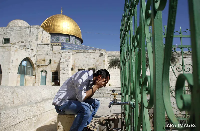 A Palestinian Muslim worshiper performs ablution before Friday prayer outside of the Dome mosque of the Rock in the Al-Aqsa mosques compound in Jerusalem's old city on February 27, 2015. Photo by Muammar Awad