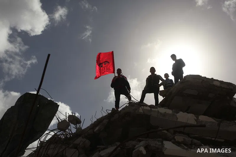 Palestinian supporters of the Popular Front for the Liberation of Palestine (PFLP) take part a protest demanding for reconstruction of houses which were destroyed during the recent Israeli war, in Biet Hanoun in the nort...