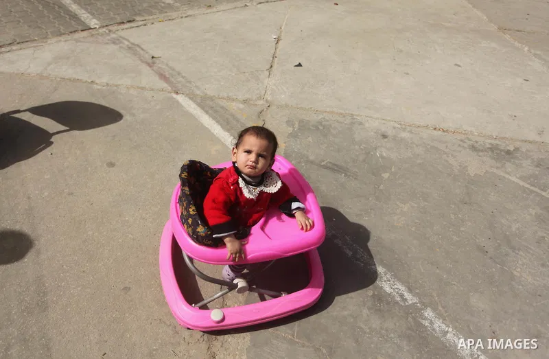 Displaced child takes shelter at Beit Hanoun School in the northern Gaza Strip February 28, 2015. More than 100,000 homes in the Gaza Strip were damaged or destroyed in Israeli bombardment during the 50-day conflict. A s...