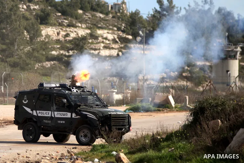 A view shows an Israeli military vehicle during clashes following demonstration demanding the release of the prisoner Lena Khattab held in Israeli jails outside Israel's Ofer military prison near the West Bank city of Ra...