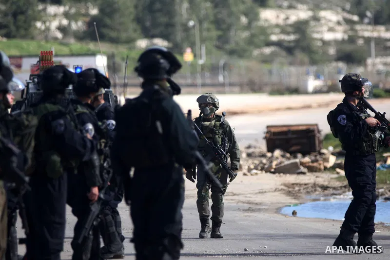 Israeli border policemen take a position during clashes following demonstration demanding the release of the prisoner Lena Khattab held in Israeli jails outside Israel's Ofer military prison near the West Bank city of Ra...
