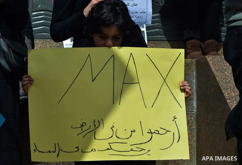 Egyptians hold placards during demonstration against killing Al-ahram's Dog at Al Jazeera square in Cairo, Egypt on February 28, 2015. Photo by Amr Sayed