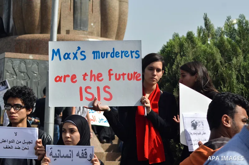 Egyptians hold placards during demonstration against killing Al-ahram's Dog at Al Jazeera square in Cairo, Egypt on February 28, 2015. Photo by Amr Sayed