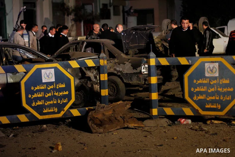 Egyptian security officials inspect the site of an explosion outside the Zahraa El-Maadi police station in Cairo, Egypt, on March 3, 2015. Photo by Amr Sayed