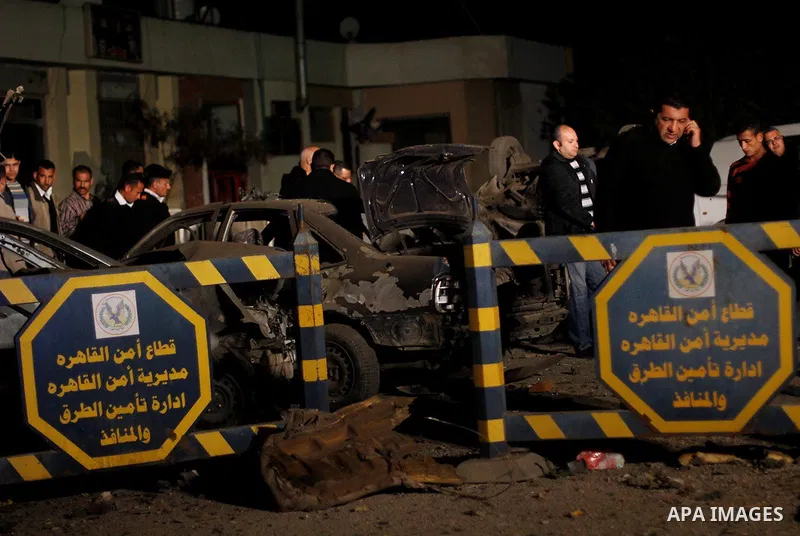 Egyptian security officials inspect the site of an explosion outside the Zahraa El-Maadi police station in Cairo, Egypt, on March 3, 2015. Photo by Amr Sayed