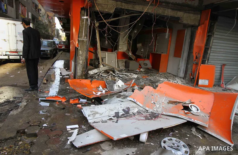 Egyptians inspect the blas site in the district of Al Matariya in eastern Cairo, on March 3, 2015. Five improvised bombs exploded early Tuesday in Cairo's Matariya district in an apparent targeting of Vodafone and Mobini...