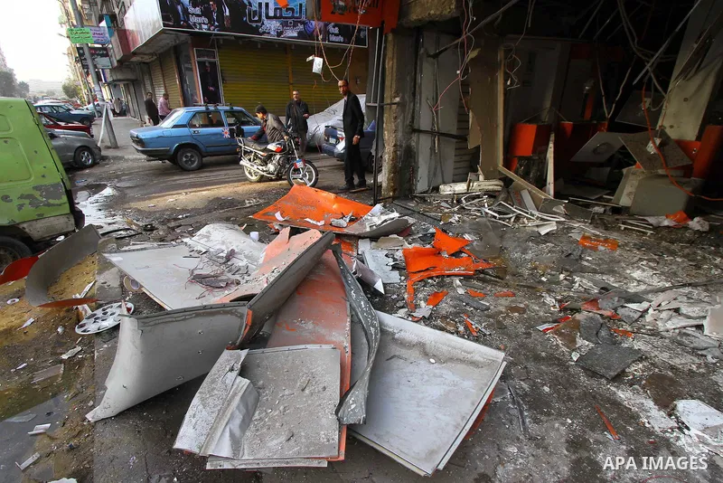 Egyptians inspect the blas site in the district of Al Matariya in eastern Cairo, on March 3, 2015. Five improvised bombs exploded early Tuesday in Cairo's Matariya district in an apparent targeting of Vodafone and Mobini...