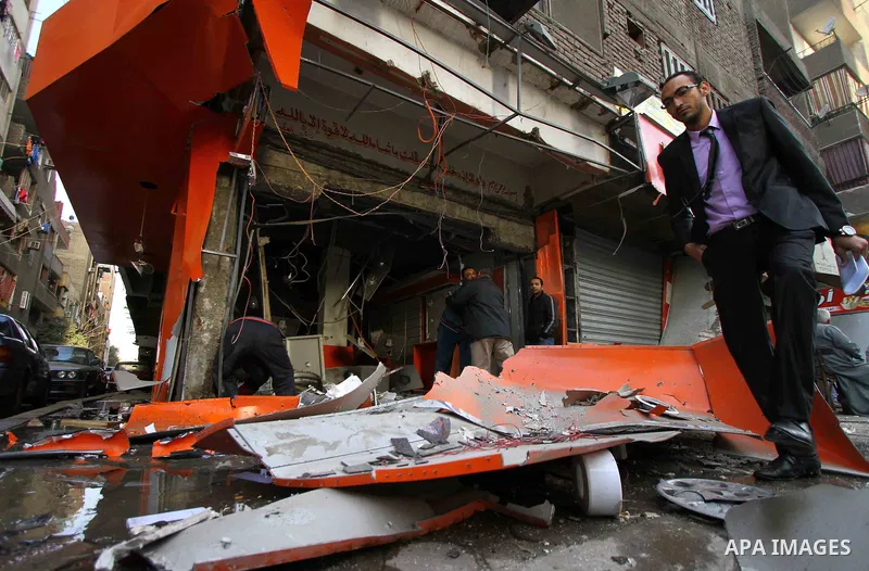 Egyptians inspect the blas site in the district of Al Matariya in eastern Cairo, on March 3, 2015. Five improvised bombs exploded early Tuesday in Cairo's Matariya district in an apparent targeting of Vodafone and Mobini...