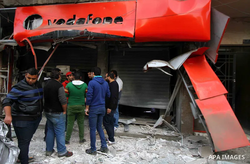 Egyptians inspect the blas site in the district of Al Matariya in eastern Cairo, on March 3, 2015. Five improvised bombs exploded early Tuesday in Cairo's Matariya district in an apparent targeting of Vodafone and Mobini...