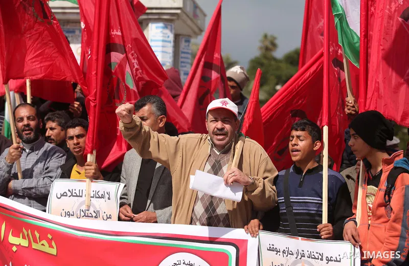 Palestinian supporters of the Popular Front for the Liberation of Palestine (PFLP) take part a protest demanding for reconstruction of houses which were destroyed during the recent Israeli war, in Gaza city, on March 04,...