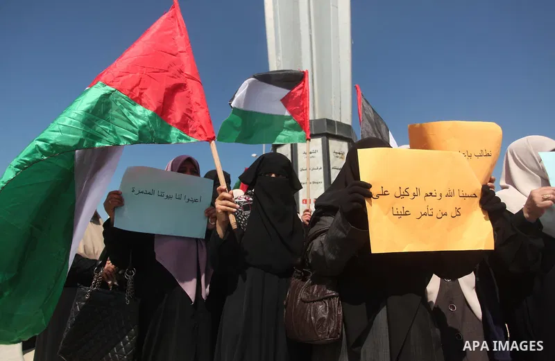 Palestinian women take part in a protest demanding for the opening of a waterway, reconstruction of houses, and to break the siege at the Gaza seaport on March 05, 2015. Photo by Ashraf Amra