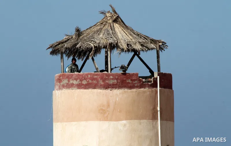 An Egyptian security guard on duty in a watch tower at the border between Egypt and southern Gaza Strip, on March 5, 2015. Gaza's border crossings will be reopened once control of them is handed over to the Palestinian A...
