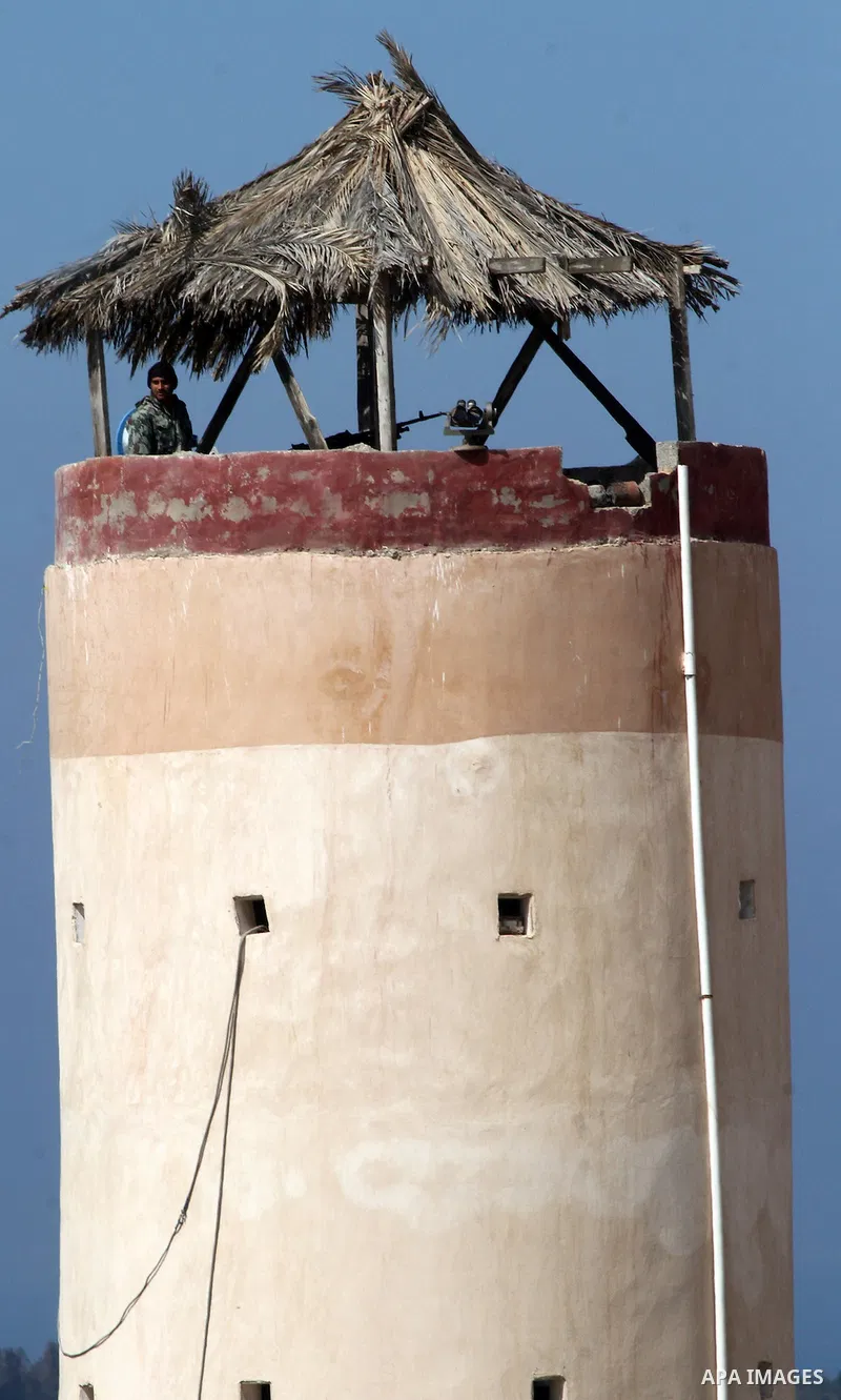An Egyptian security guard on duty in a watch tower at the border between Egypt and southern Gaza Strip, on March 5, 2015. Gaza's border crossings will be reopened once control of them is handed over to the Palestinian A...