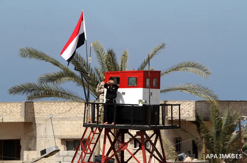 An Egyptian security guard on duty in a watch tower at the border between Egypt and southern Gaza Strip, on March 5, 2015. Gaza's border crossings will be reopened once control of them is handed over to the Palestinian A...