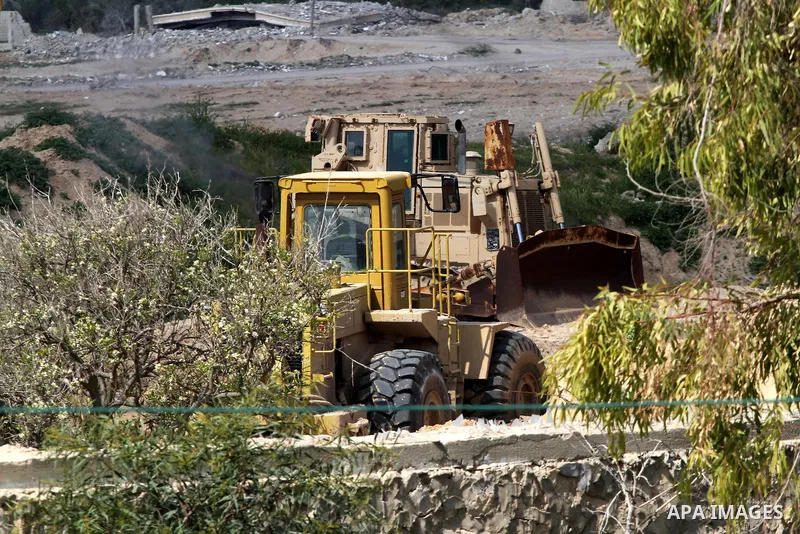 Bulldozers are seen work at the Egyptian side of the border between Egypt and southern Gaza Strip, in Rafah on March 5, 2015. Gaza's border crossings will be reopened once control of them is handed over to the Palestinia...