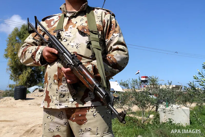 A member of Palestinian security forces stands guard on the border between Egypt and southern Gaza Strip, in Rafah on March 5, 2015. Gaza's border crossings will be reopened once control of them is handed over to the Pal...