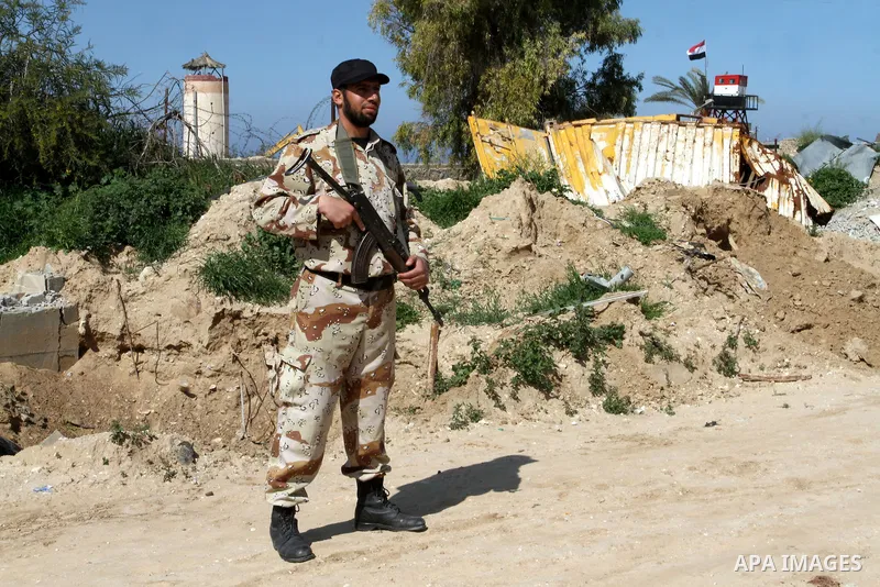 A member of Palestinian security forces stands guard on the border between Egypt and southern Gaza Strip, in Rafah on March 5, 2015. Gaza's border crossings will be reopened once control of them is handed over to the Pal...
