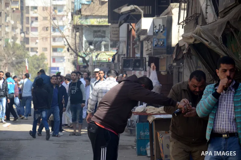 Egyptian supporters of Muslim Brotherhood and ousted president Mohammed Morsi, holds placards run for cover during clashes with riot police in a demonstration against the military rule, in al-Haram district, near Cairo M...