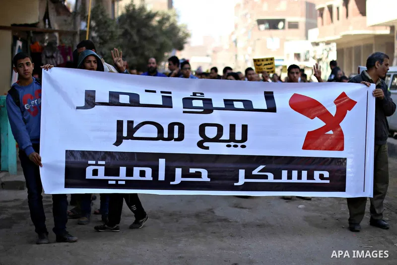 Egyptian supporters of Muslim Brotherhood and ousted president Mohammed Morsi, holds placards during a demonstration against the military rule, in al-Haram district, near Cairo March 6, 2015. Photo by Amr Sayed