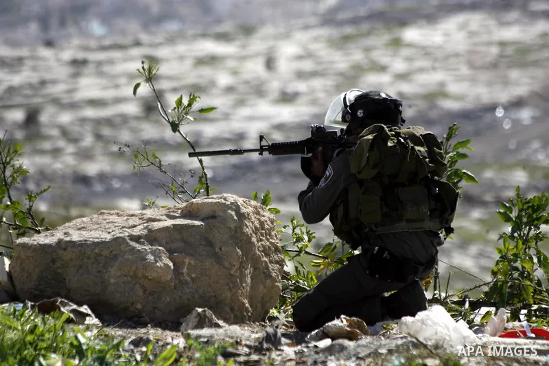 An Israeli border policeman aims at Palestinian protesters during clashes after clear a protest on land that Palestinians say was confiscated by Israel for Jewish settlements, near the West Bank town of Abu Dis near Jeru...