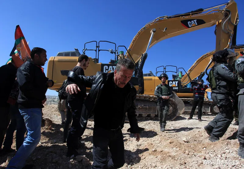 Israeli border policemen scuffle with Palestinian protesters as they clear a protest on land that Palestinians say was confiscated by Israel for Jewish settlements, near the West Bank town of Abu Dis near Jerusalem March...