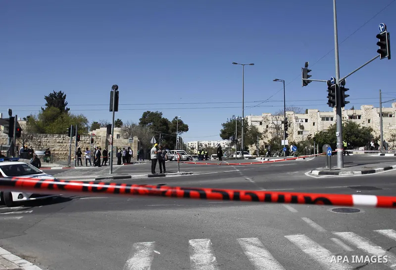 Israeli border guards stand near a car that ploughed into pedestrians in Jerusalem injuring several people, before its driver got out and tried to stab them, in an attack mirroring similar incidents last year, on March 6...