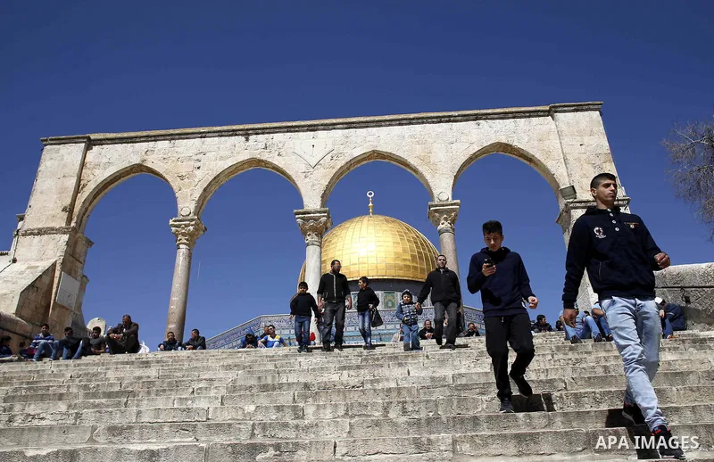 Palestinian Muslim worshipers perform the Friday prayer outside of the Dome mosque of the Rock in the Al-Aqsa mosques compound in Jerusalem's old city on March 6, 2015. Photo by Muammar Awad