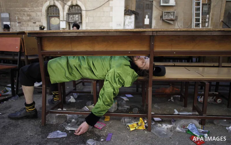 An ultra-Orthodox Jewish man sleeps at a Yeshiva during celebration marking the Jewish holiday of Purim in Jerusalem's Mea Shearim neighbourhood March 6, 2015. Purim is a celebration of the Jews' salvation from genocide...