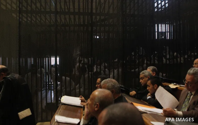 Suspects in the 'Port Said Massacre' case, stand in a courtroom cage during their trial in Cairo on March 7, 2015. Port said Criminal court adjourned the so-called Case “Port Said Massacre” retrial to Tomorrow . The defe...