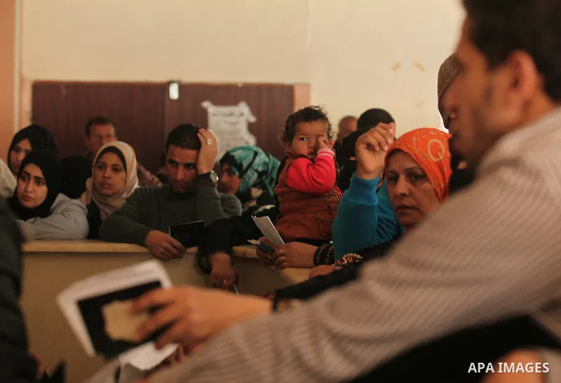 Palestinians ask for travel permits to cross into Egypt, at the Rafah crossing between Egypt and the southern Gaza Strip March 9, 2015. Egyptian authorities opened the Rafah border crossing on Monday for two days, offici...