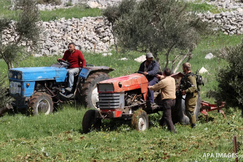 Israeli soldiers expel Palestinian farmers and shepherds from their fields after attacking Israeli settlers to them at at Burin village near the West Bank city of Nablus on March 09 2015. Photo by Nedal Eshtayah