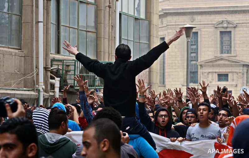 Al-Zamalek soccer club fans known as 'Ultras White Knights" light flares and shout slogans during a protest against interior ministry after the riot that killed more than 20 soccer fans last month, at Cairo University on...