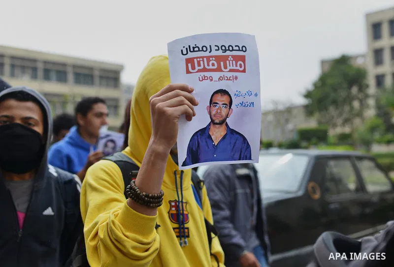 An Egyptian student who support Muslim Brotherhood and ousted president Mohammed Morsi, holds a picture of his fellow during a demonstration against military rule, at Cairo University, in Cairo, March 10, 2015. Photo by...