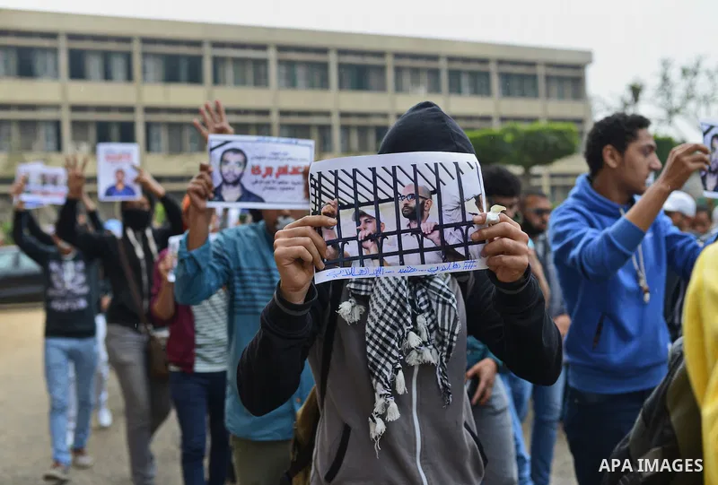 Egyptian students who support Muslim Brotherhood and ousted president Mohammed Morsi, hold pictures of their fellows during a demonstration against military rule, at Cairo University, in Cairo, March 10, 2015. Photo by A...