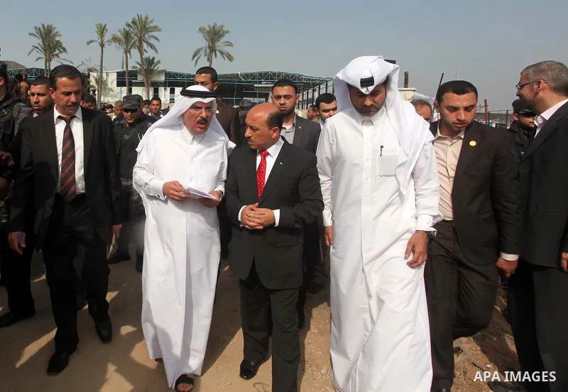 Qatar's Ambassador to the Palestinian Authority, Mohammed Al Emadi looks the rubbles of El-Wafa hospital, which witnesses said was destroyed during a seven-week Israeli offensive, in the east of Gaza City March 10, 2015....