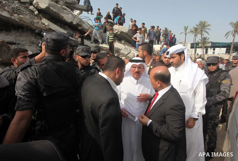 Qatar's Ambassador to the Palestinian Authority, Mohammed Al Emadi looks the rubbles of El-Wafa hospital, which witnesses said was destroyed during a seven-week Israeli offensive, in the east of Gaza City March 10, 2015....