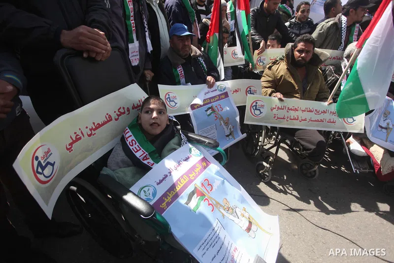 Palestinians take part in a rally in front of the United Nations Development Programme office (UNDP) on the occasion of the Palestinian Wounded's Day in Gaza City on March 12, 2015. Photo by Ashraf Amra