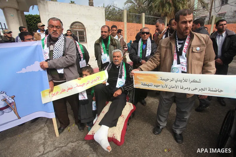 Palestinians take part in a rally in front of the United Nations Development Programme office (UNDP) on the occasion of the Palestinian Wounded's Day in Gaza City on March 12, 2015. Photo by Ashraf Amra