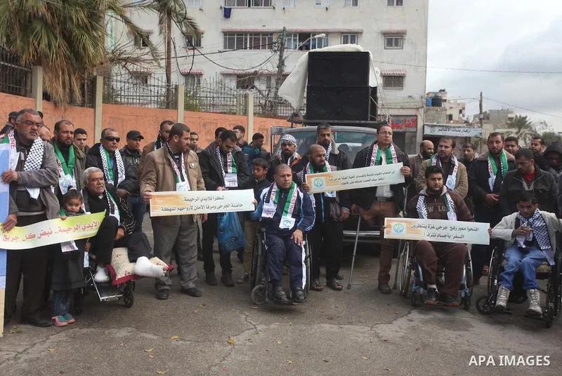 Palestinians take part in a rally in front of the United Nations Development Programme office (UNDP) on the occasion of the Palestinian Wounded's Day in Gaza City on March 12, 2015. Photo by Ashraf Amra