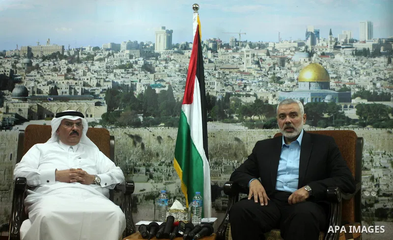Senior Hamas leader Ismail Haniyeh meets with Qatar's Ambassador to the Palestinian Authority, Mohammed Al Emadi at his home, in Gaza city, on March 12, 2015. Photo by Ashraf Amra