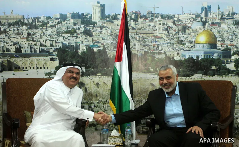 Senior Hamas leader Ismail Haniyeh meets with Qatar's Ambassador to the Palestinian Authority, Mohammed Al Emadi at his home, in Gaza city, on March 12, 2015. Photo by Ashraf Amra