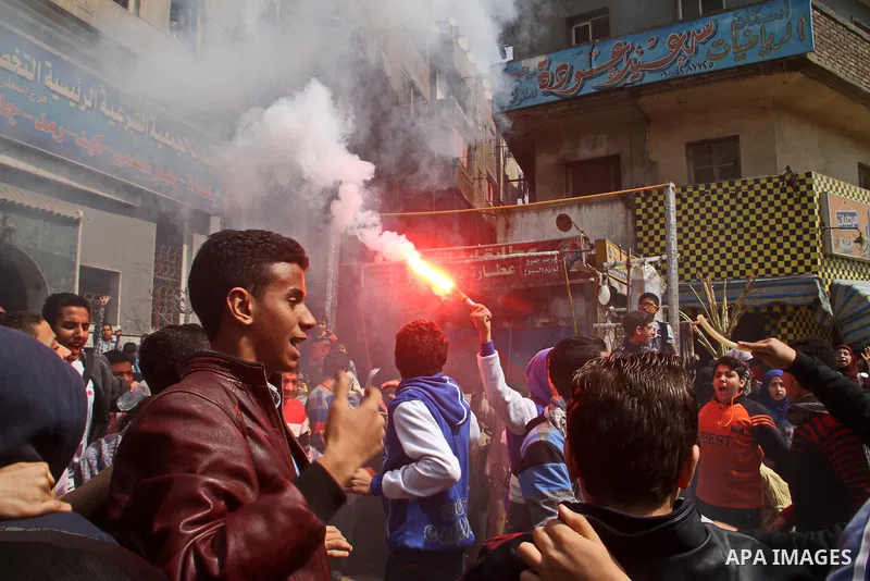 Egyptian supporters of Muslim Brotherhood and ousted President Mohammed Morsi, light up flares during a demonstration against military rule, in the Cairo suburb of Matariya, on March 13, 2015. Photo by Amr Sayed